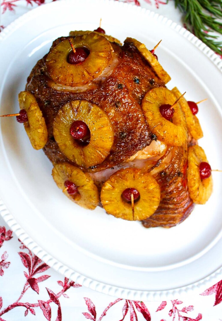 A roasted ham with pineapple on a plate