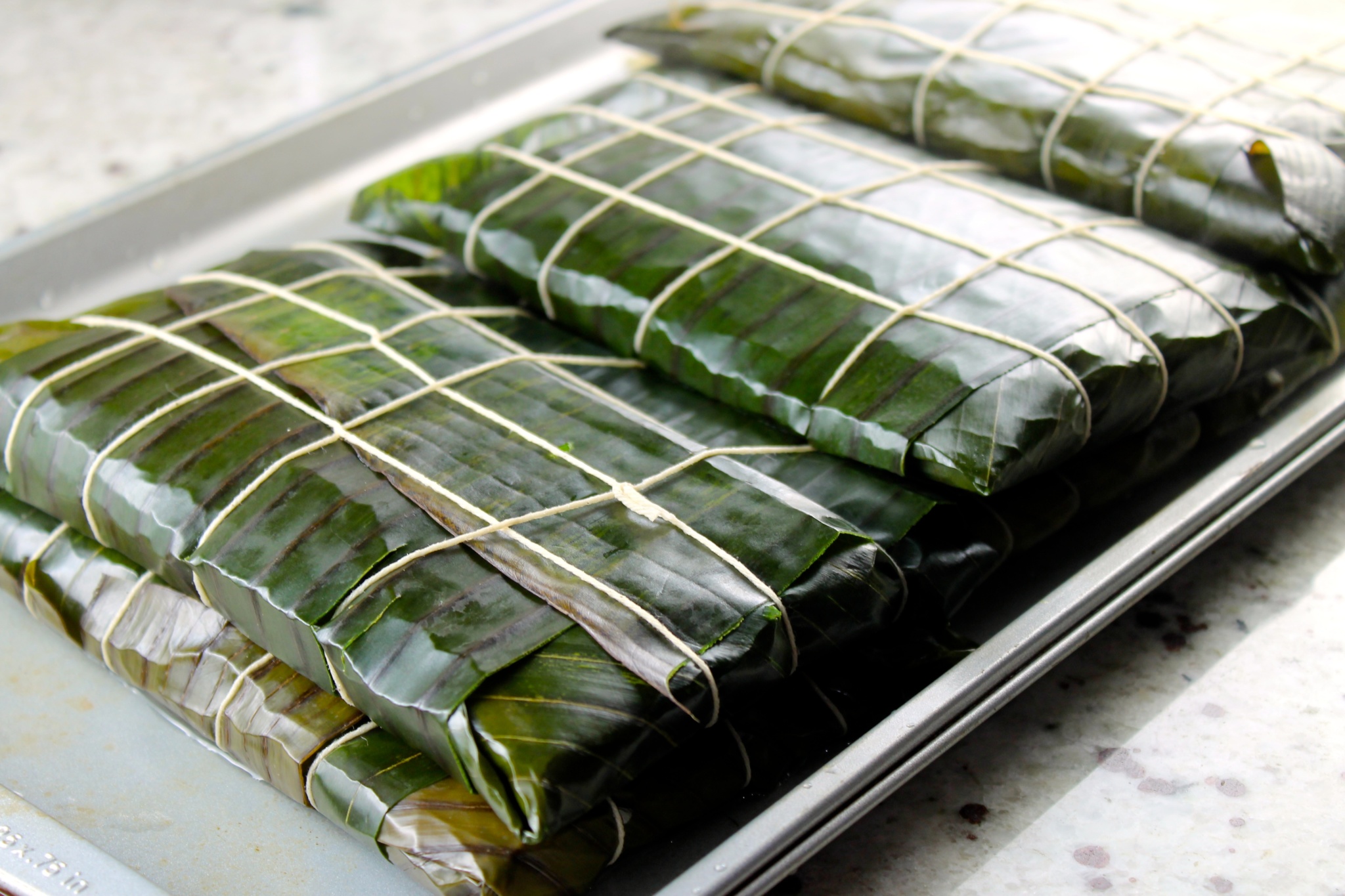 Hallacas already made, in a tray.
