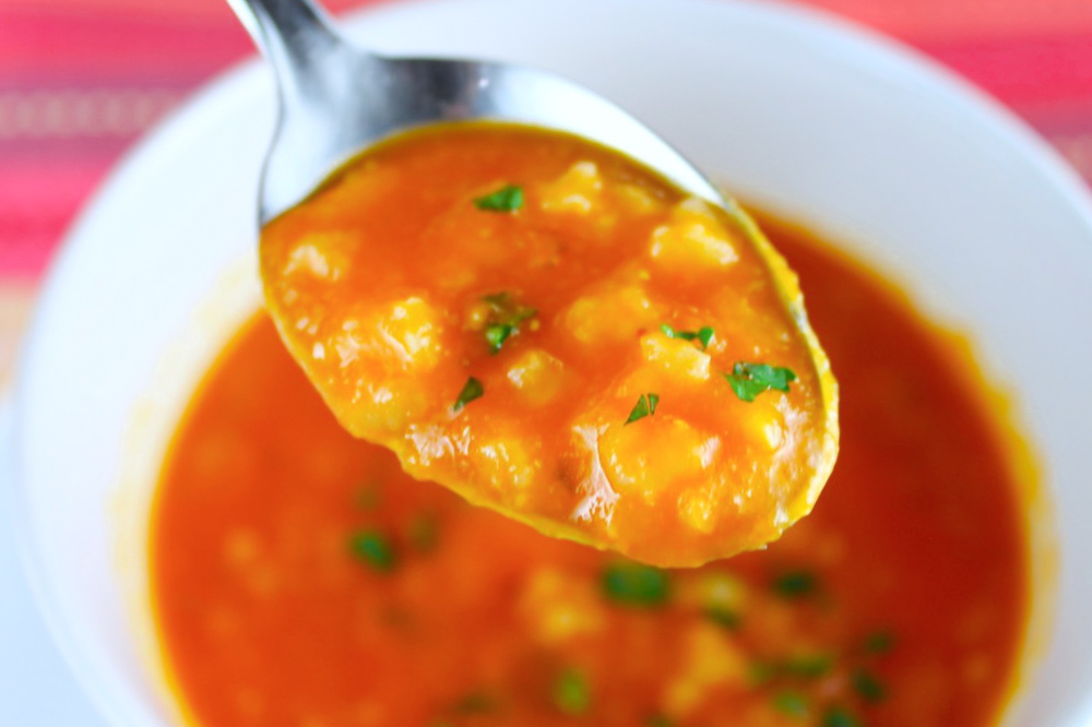 a full spoon of tomato and rosematy soup by enrilemoine
