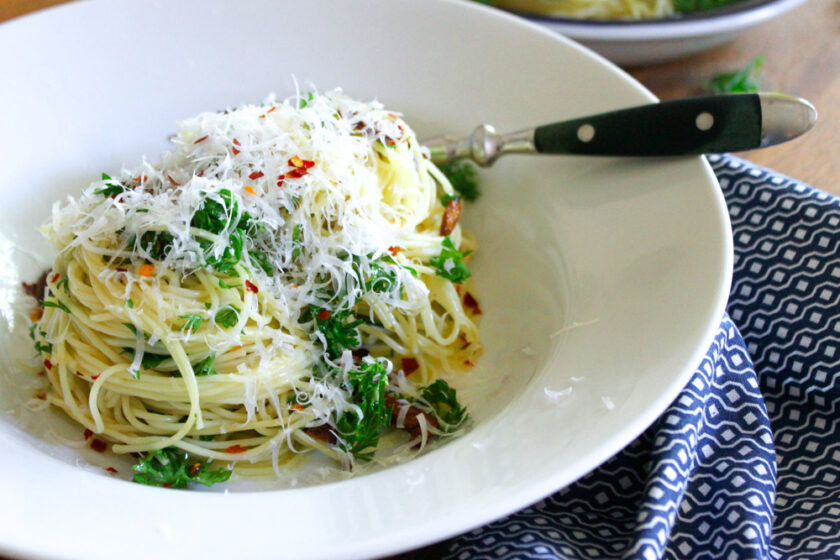 Pasta aglio, olio e peperoncino, served with Parmesan cheese.
