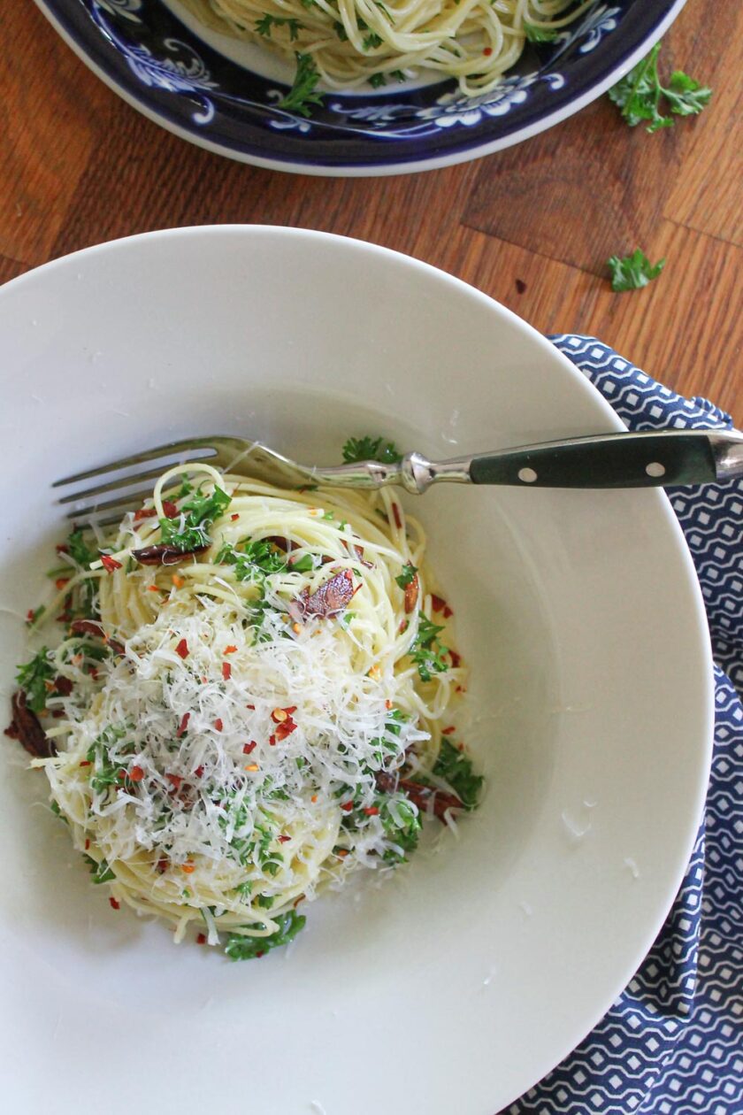 Pasta aglio e olio with peperoncino and Parmesan cheese, already served.