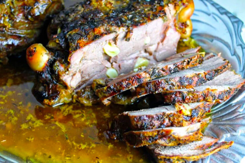 Mediterranean roasted leg of lamb with a rosemary crust, already sliced , served on a pewter plate.