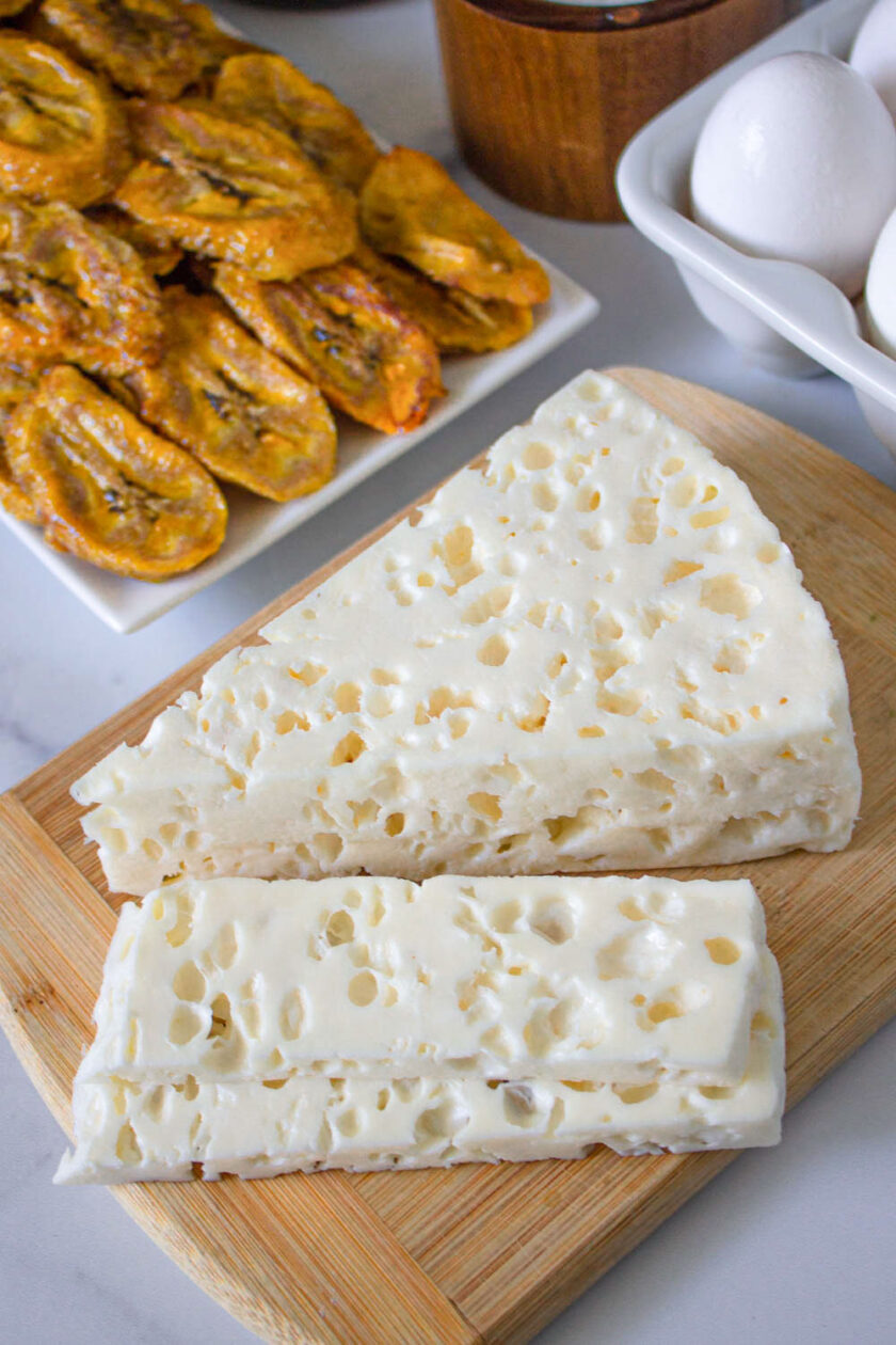 Close uo of Venezuelan palmita cheese. You can also see some tajadas de plátano.