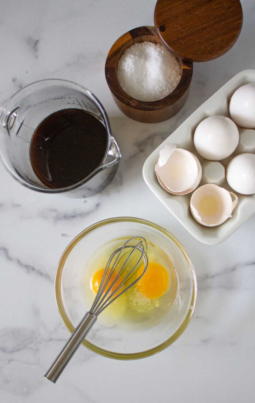 Eggs and papelón syrup to make torta de plátano with white cheese.