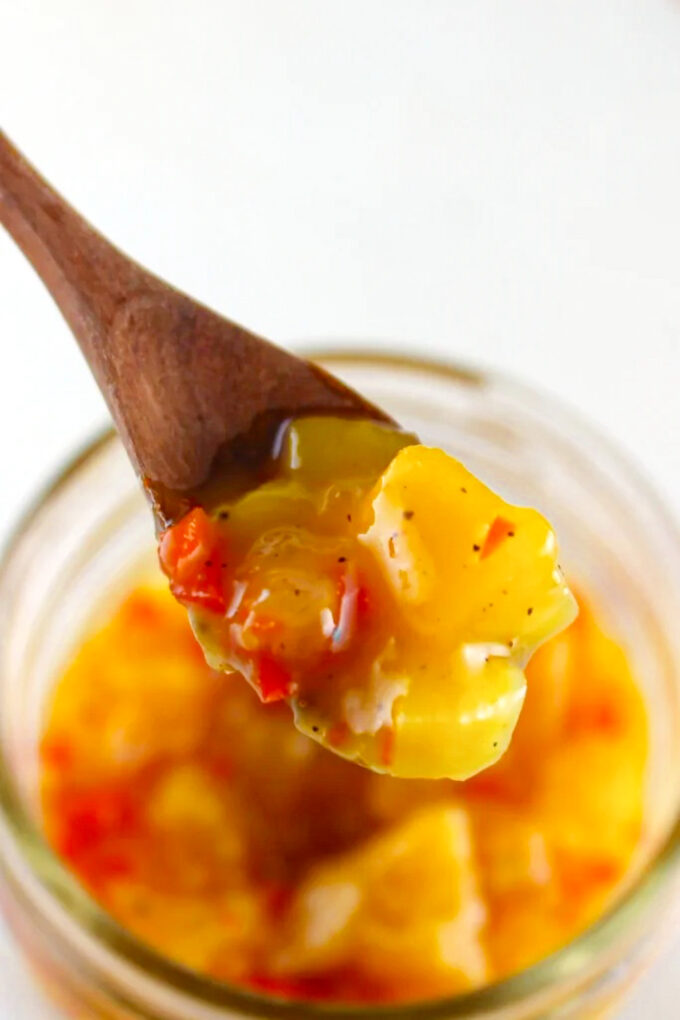 Close up of a wooden spoon with mango chutney, by enrilemoine.