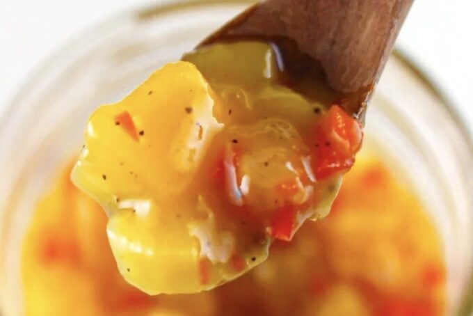 Close up of a wooden spoon with mango chutney, by enrilemoine.