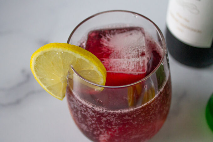 A glass of Tinto de Verano, a Spanish summer red wine recipe featuring lemon, by enrilemoine.