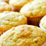 A group of grilled corn jalapeño cheddar cornbread muffins on a white plate, by enrilemoine