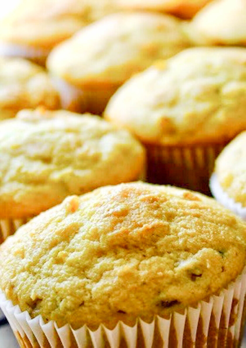 A group of grilled corn jalapeño cheddar cornbread muffins on a white plate, by enrilemoine