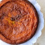 A Venezuelan Torta de Jojoto, a corn pudding recipe, is presented on a white plate.