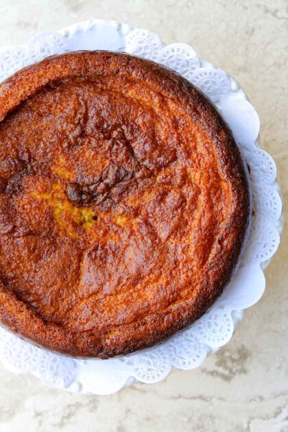 A Venezuelan Torta de Jojoto, a corn pudding recipe, is presented on a white plate.