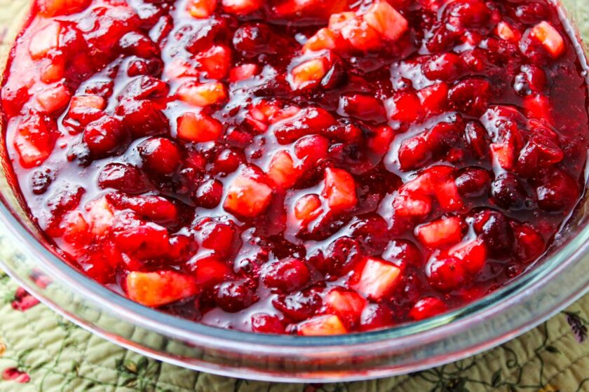 Fresh cranberry and pineapple sauce in a glass bowl.