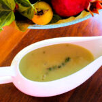 A gravy boat with turkey gravy.