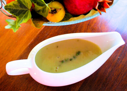 A gravy boat with turkey gravy.