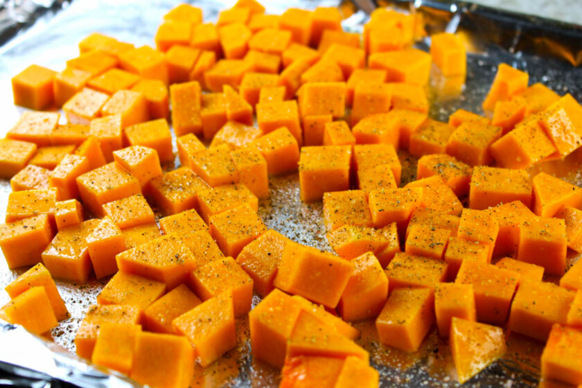 Cubed butternut squash on a baking sheet.