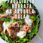 Fig prosciutto, burrata and arugula salad with olive oil.