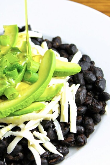Refried black beans with white cheese and avocado.