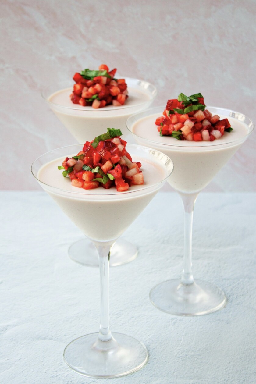 Three martini glasses with strawberry panna cotta.