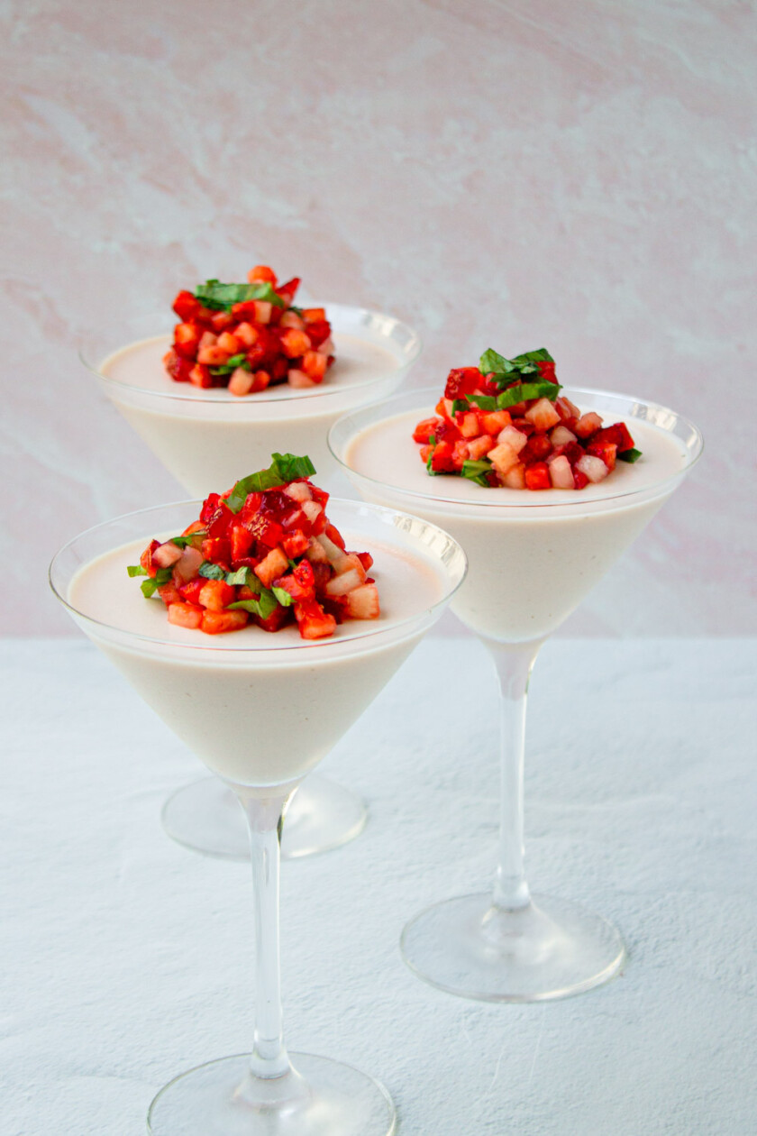 Strawberry panna cotta served on three martini glasses.