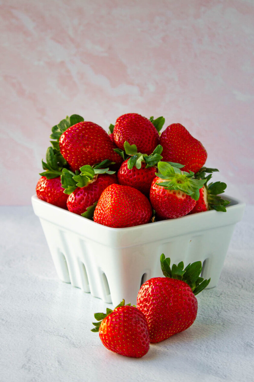 Fresas frescas en un recipiente bloanco de carámica.