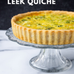 Leek quiche on a glass cke pedestal.