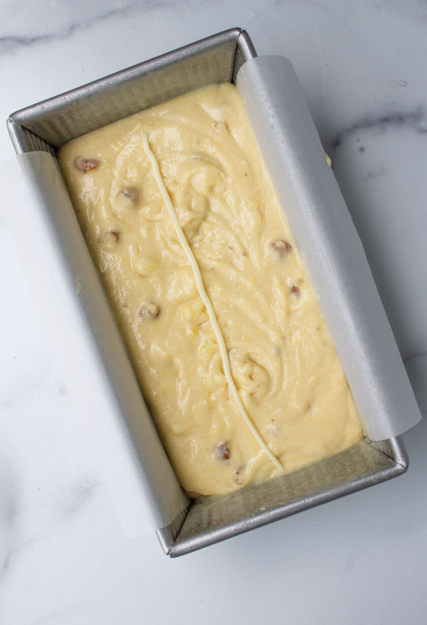 bizcocho de limón antes de entrar al horno, en un molde con papel pergamino.