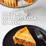 Una tarta de atún con una rodaja en un plato negro, expuesta junto a la tarta entera, con el texto en español "receta de polvorosa de atún" encima.