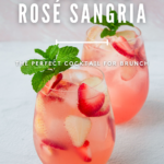 Two glasses of sparkling rosé sangria garnished with strawberries and mint, ideal for brunch.