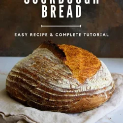 A loaf of sourdough bread on a cloth, with text overlay: "How to Make Sourdough Bread. Easy Recipe & Complete Tutorial. enrilemoine.com.