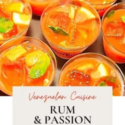 Several clear cups filled with a bright orange drink containing fruit pieces, mint leaves, and ice, labeled as Venezuelan rum and passion fruit Guarapita.