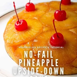 A pineapple upside-down cake topped with cherries on a white plate, made in estilo venezolano. Text overlay reads: "No-Fail Pineapple Upside-Down Cake.