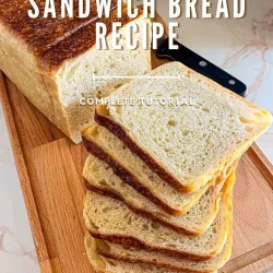 Sliced sandwich sourdough bread on a wooden board with a knife; text overlay reads "Sourdough Sandwich Bread Recipe".
