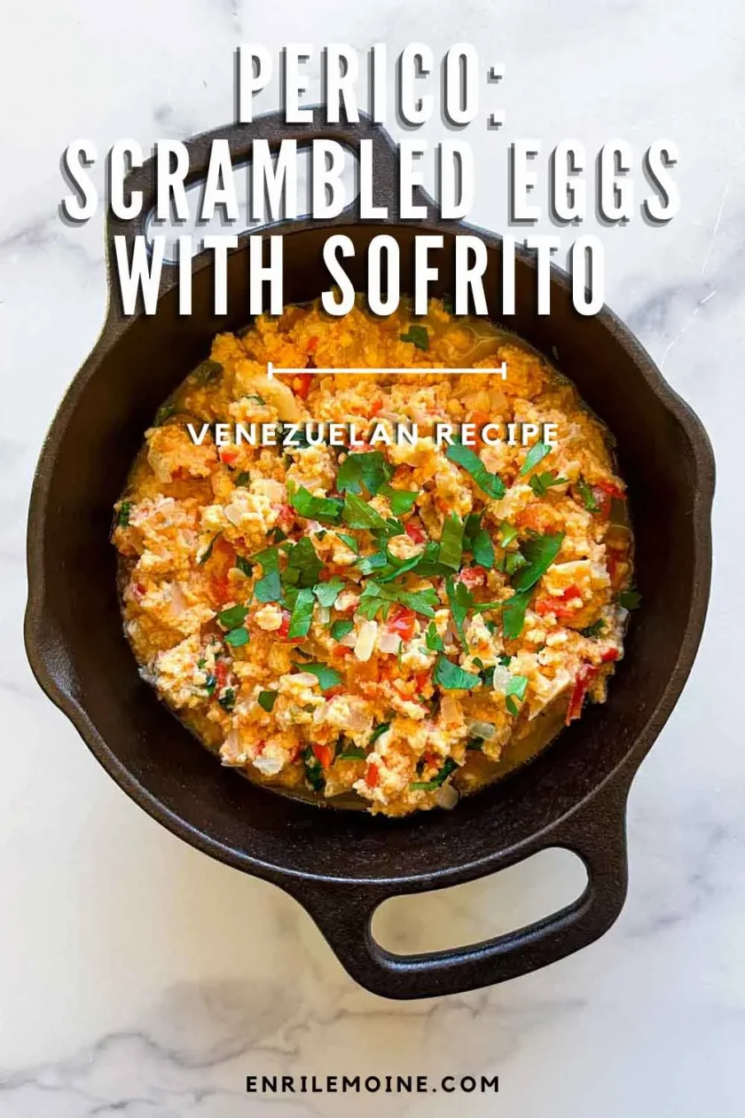 A cast-iron skillet with Perico, Venezuelan scrambled eggs with sofrito, topped with fresh herbs.