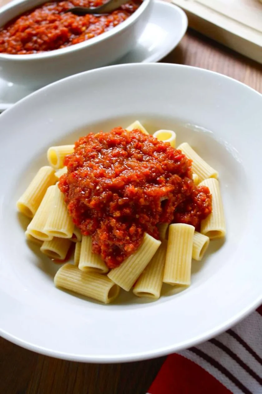 A pasta bowl with cokked rigatoni dressed with fake Bolognese sauce.