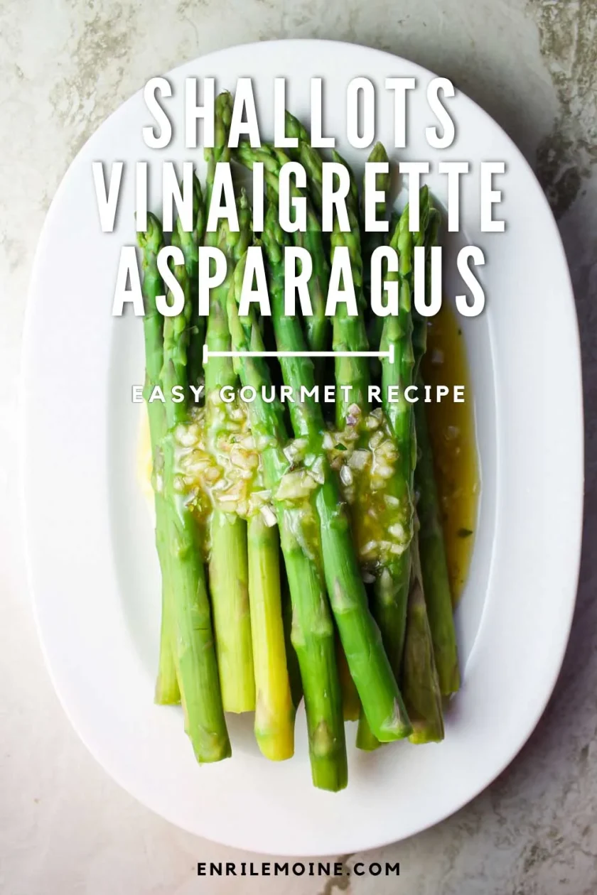 asapagus with a shallot vinaigrette on white oval dish over a marble surface.