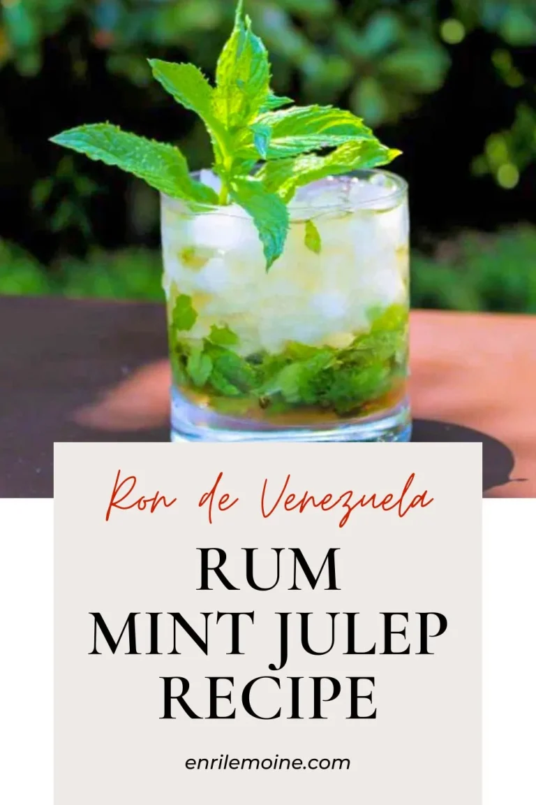 A glass of rum mint julep with crushed ice and fresh mint garnish, placed outdoors, with text: "Ron de Venezuela Rum Mint Julep Recipe enrilemoine.com".