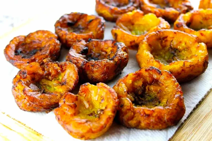 Fried ripe plantain cups on a paper towel.